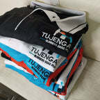 Stack of folded polo shirts with logo embroidery.