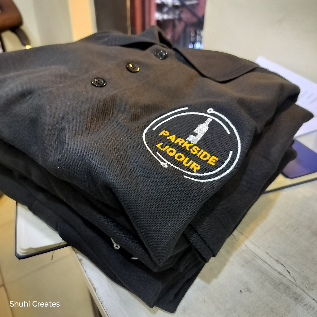 Folded black polo tshirt with logo embroidery.