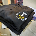 Folded black polo tshirt with logo embroidery.