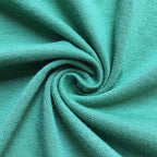 Close-up of teal fabric with a swirl pattern