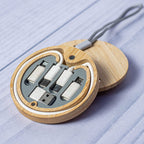Set of USB cables and connectors in a wooden case on a light blue surface